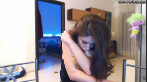 Stunning babe smokes and plays with her cat on camera